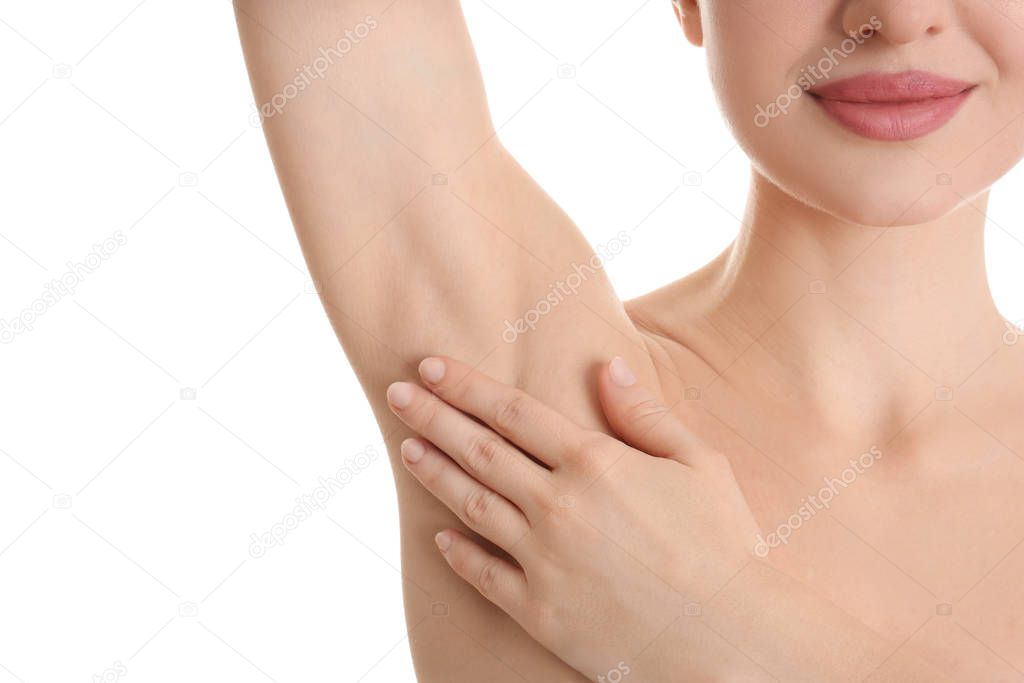 Young beautiful woman showing armpit with smooth clean skin on white background, closeup