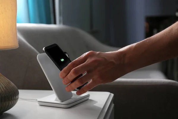 Man Putting Smartphone Wireless Charger Room Closeup — Stock Photo, Image