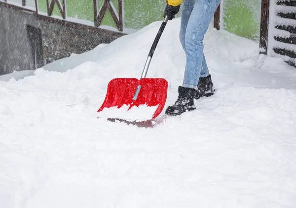 屋外のシャベルで雪を掃除する男 — ストック写真