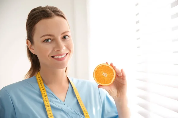 Voedingsdeskundige Met Oranje Bij Venster Kantoor — Stockfoto