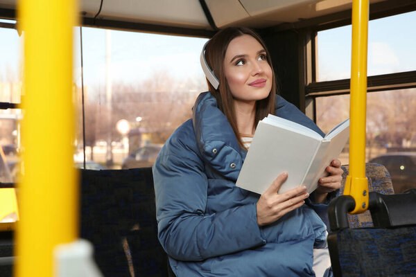 Woman listening to audiobook in trolley bus