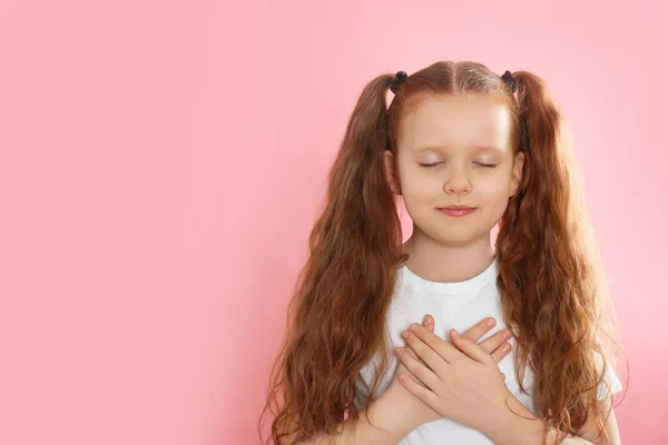Мила Вдячна Маленька Дівчинка Руками Грудях Рожевому Тлі Простір Тексту — стокове фото