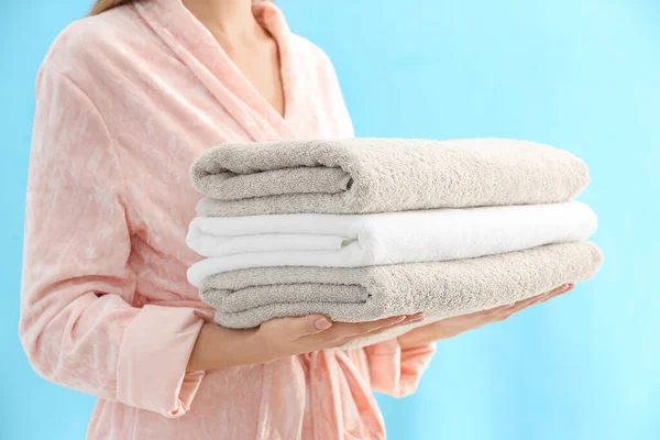 Woman Holding Stack Fresh Clean Towels Light Blue Background Closeup — ストック写真