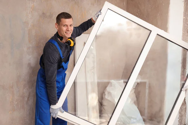 Worker in uniform with plastic window indoors