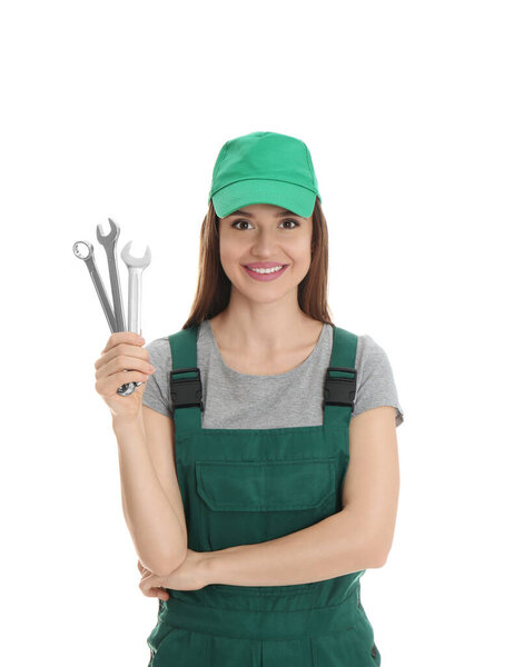 Portrait of professional auto mechanic with wrenches on white background