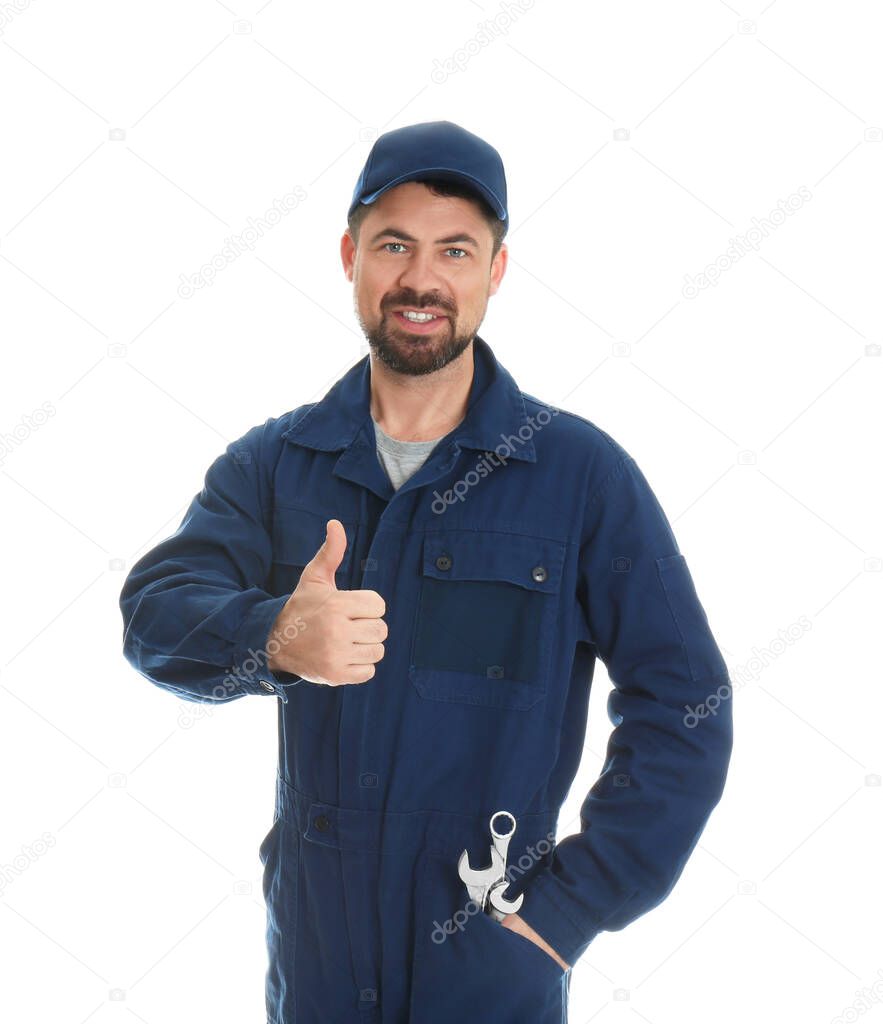 Portrait of professional auto mechanic with wrenches on white background