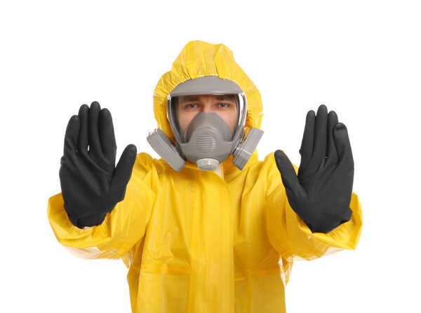 Man in chemical protective suit making stop gesture on white background. Virus research