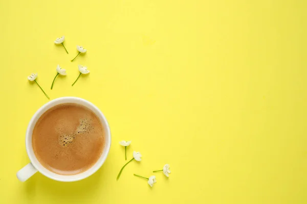 White flowers and coffee on yellow background, flat lay with space for text. Good morning