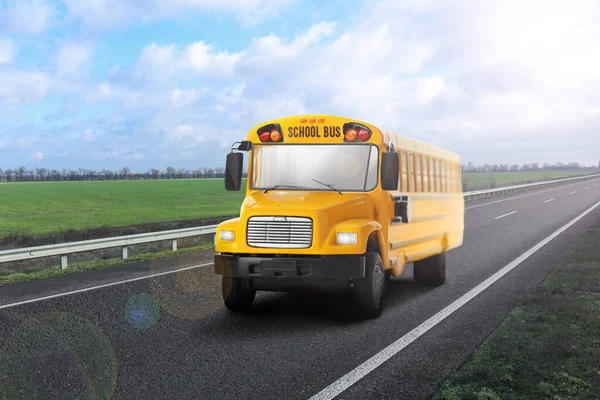 Yellow school bus on road outdoors. Transport for students