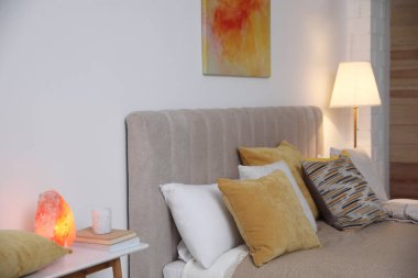 Şık oda içinde yumuşak yastıklı rahat bir yatak.