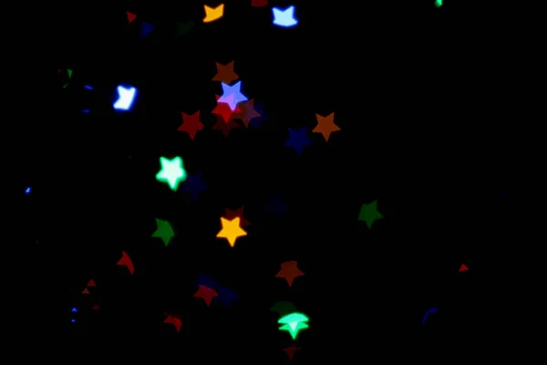 Vista Turva Luzes Coloridas Forma Estrela Fundo Preto Efeito Bokeh — Fotografia de Stock