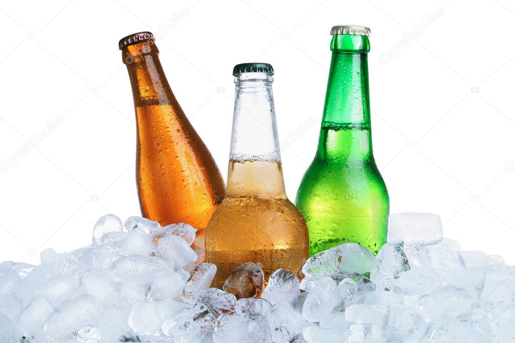 Ice cubes and different bottles on white background