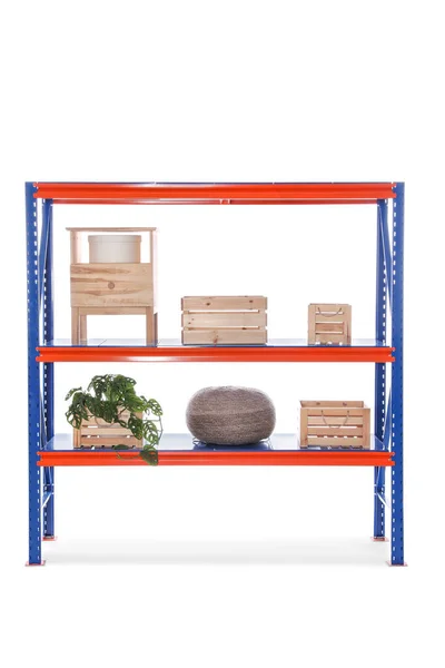 Bright metal shelving unit with wooden crates and houseplant on white background