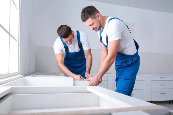 Maintenance Workers Installing New Kitchen Furniture Indoors — Stock Photo, Image