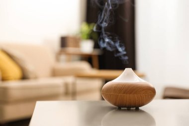 Aroma yağı yayıcı evdeki ışık masasında, mesaj için yer var. Oda spreyi