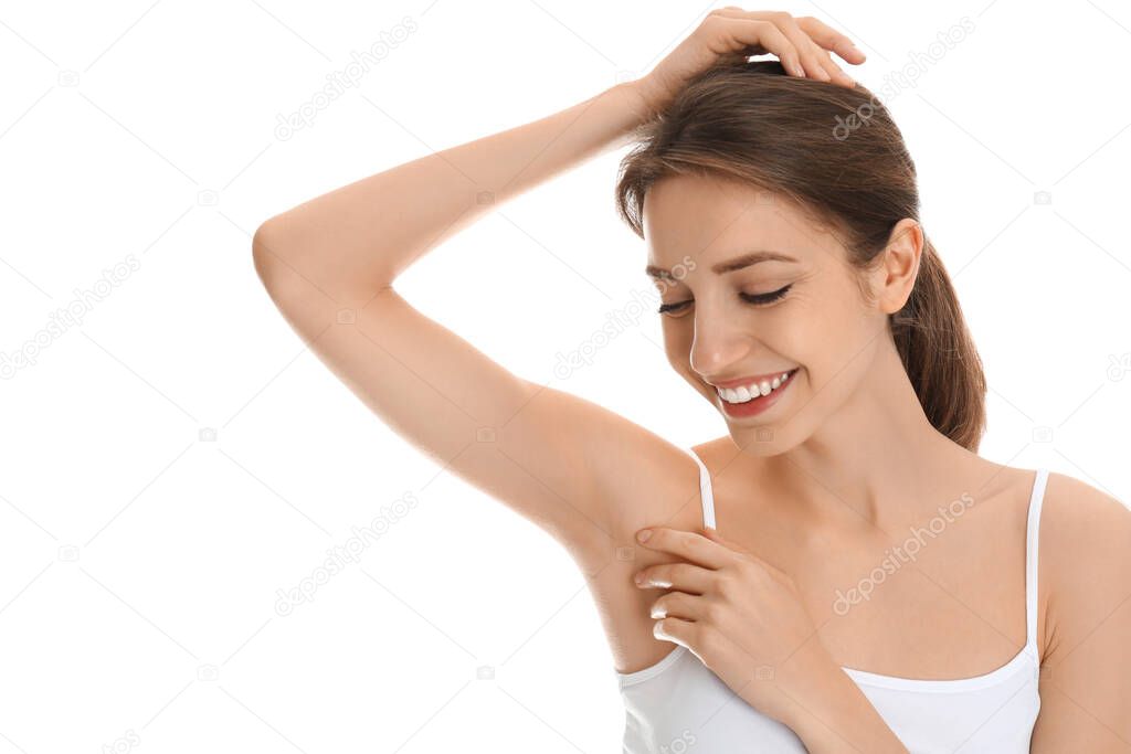 Young woman showing armpit with smooth clean skin on white background