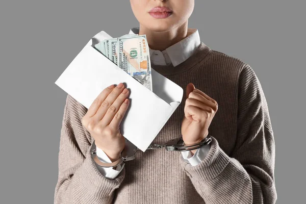 Kelepçeli Bir Kadın Gri Arka Planda Rüşvet Parası Tutuyor Yakın — Stok fotoğraf