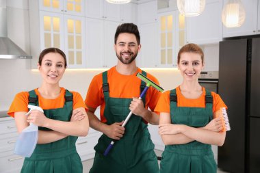 Team of professional janitors in kitchen. Cleaning service clipart
