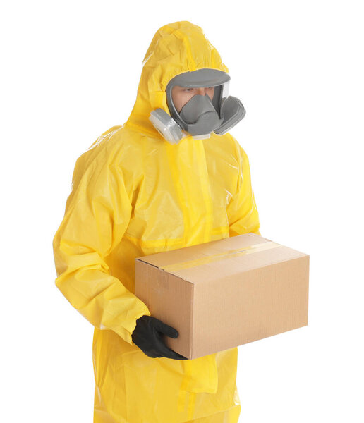 Man wearing chemical protective suit with cardboard box on white background. Prevention of virus spread
