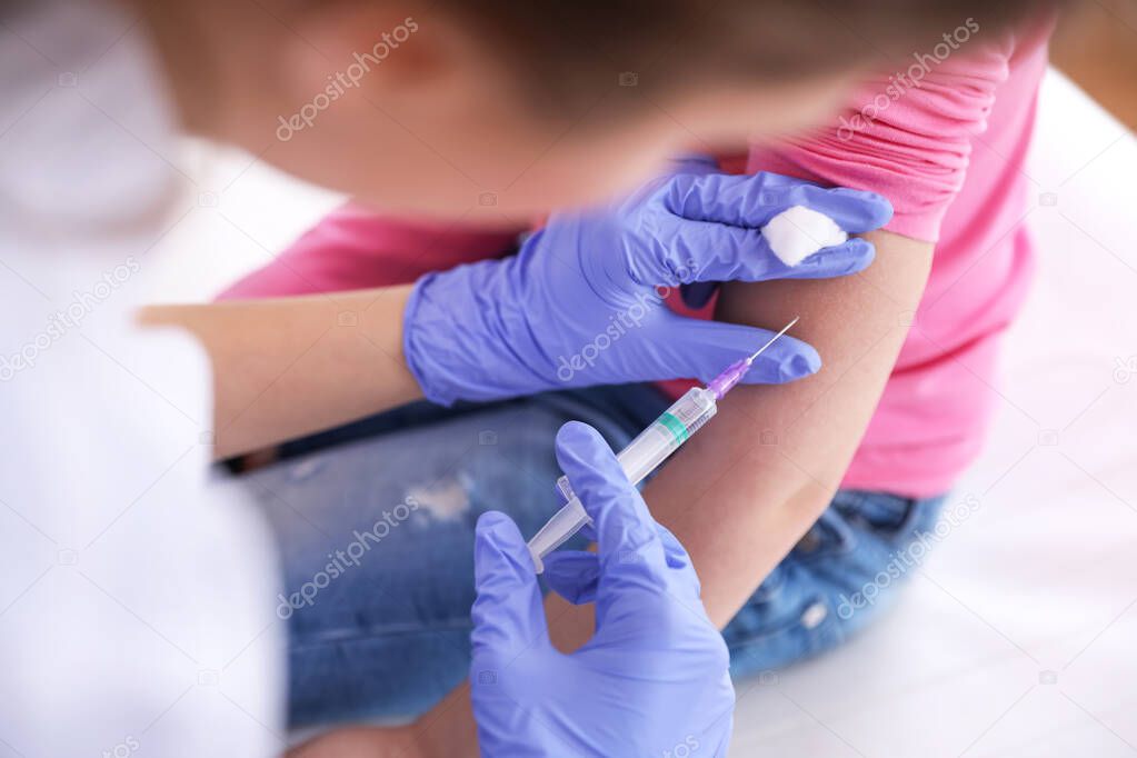 Little girl receiving chickenpox vaccination in clinic, closeup. Varicella virus prevention