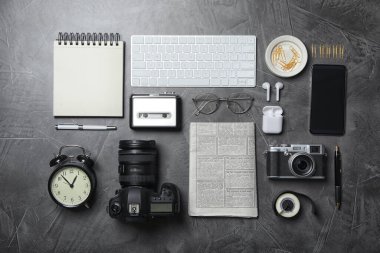 Flat lay composition with equipment for journalist on grey table