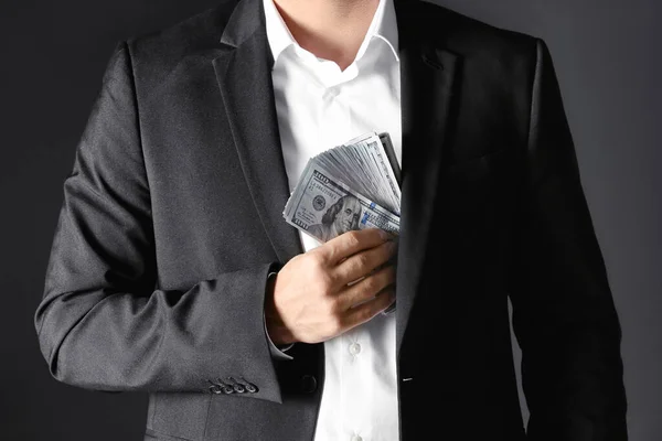 Hombre Poniendo Dinero Soborno Bolsillo Sobre Fondo Negro Primer Plano — Foto de Stock