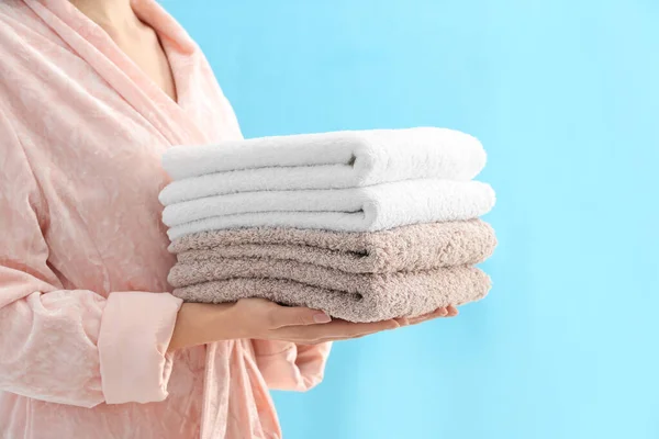 Woman Holding Stack Fresh Clean Towels Light Blue Background Closeup — ストック写真