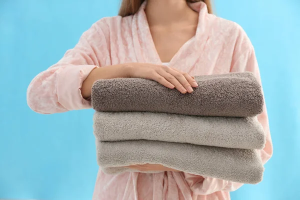 Woman Holding Stack Fresh Clean Towels Light Blue Background Closeup — Stock Photo, Image