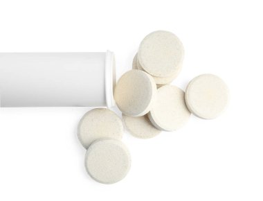Vitamin hapları içeren şişe beyaz, üst görünümde.