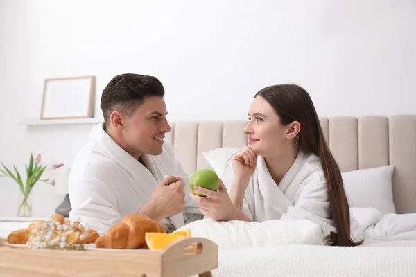 Pareja Feliz Albornoces Desayunando Cama Casa — Foto de Stock