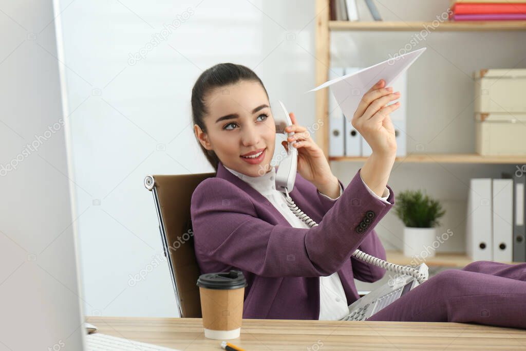 Lazy employee playing with paper plane in office