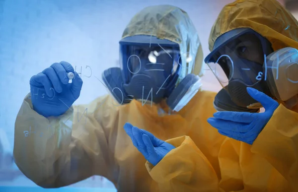 Scientists Chemical Protective Suits Writing Formula Glass Board Laboratory Virus — Stock Photo, Image