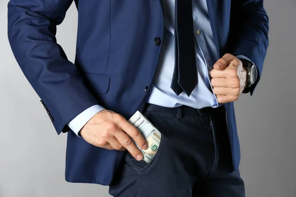Man Putting Bribe Pocket Grey Background Closeup — 스톡 사진