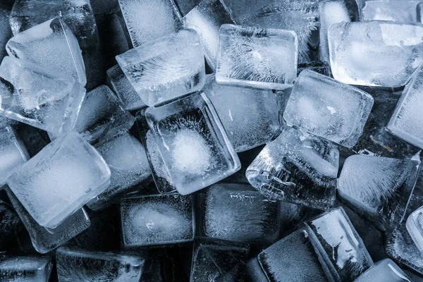 Pile of ice cubes as background, top view