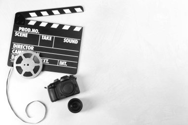 Film alkışı, modern kamera ve ışık masasında video yapımı için makara. Metin için boşluk