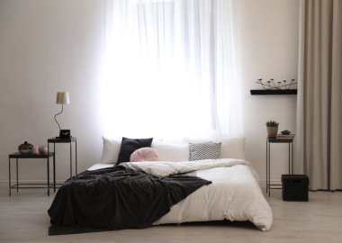 Büyük, rahat bir yatağı olan şık bir oda.