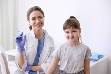 Little girl receiving chickenpox vaccination in clinic. Varicella virus prevention clipart