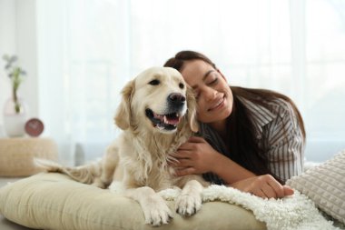 Genç kadın ve onun Golden Retriever 'ı evde. Sevimli hayvan.