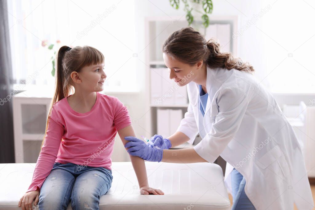 Little girl receiving chickenpox vaccination in clinic. Varicella virus prevention