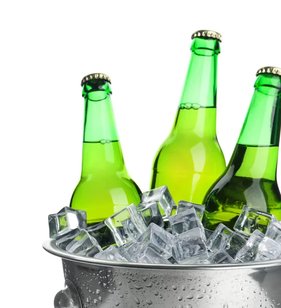 Metal bucket with bottles of beer and ice cubes isolated on white