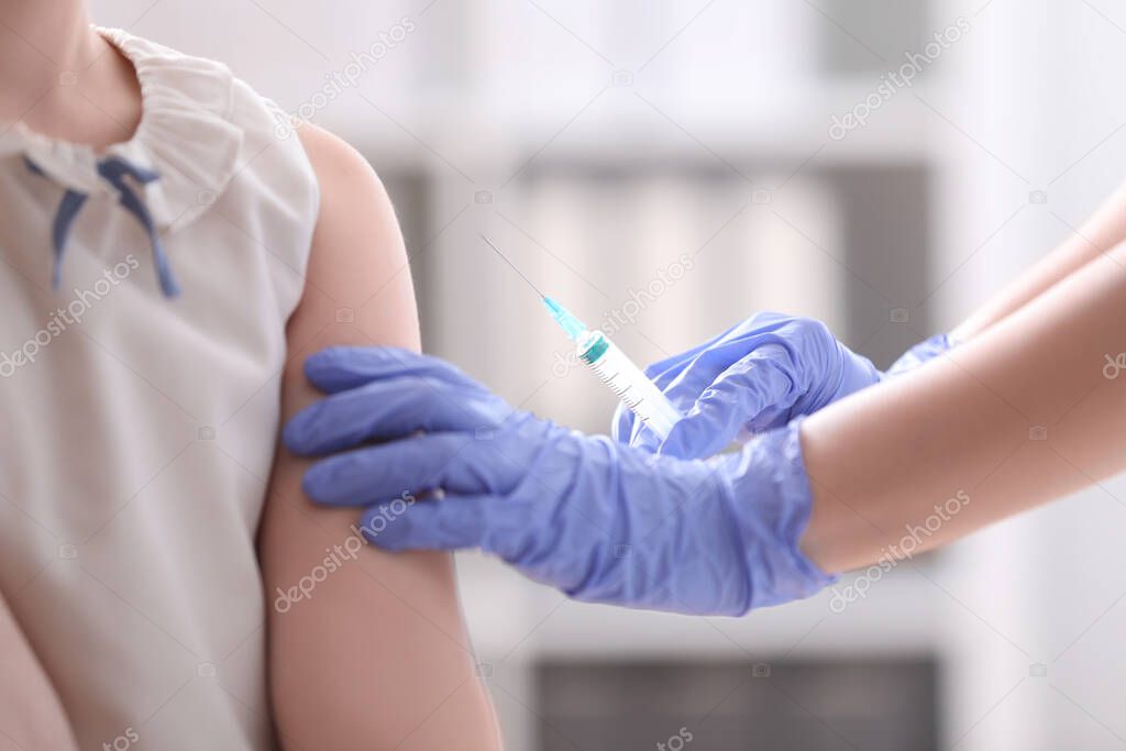 Little girl receiving chickenpox vaccination in clinic. Varicella virus prevention