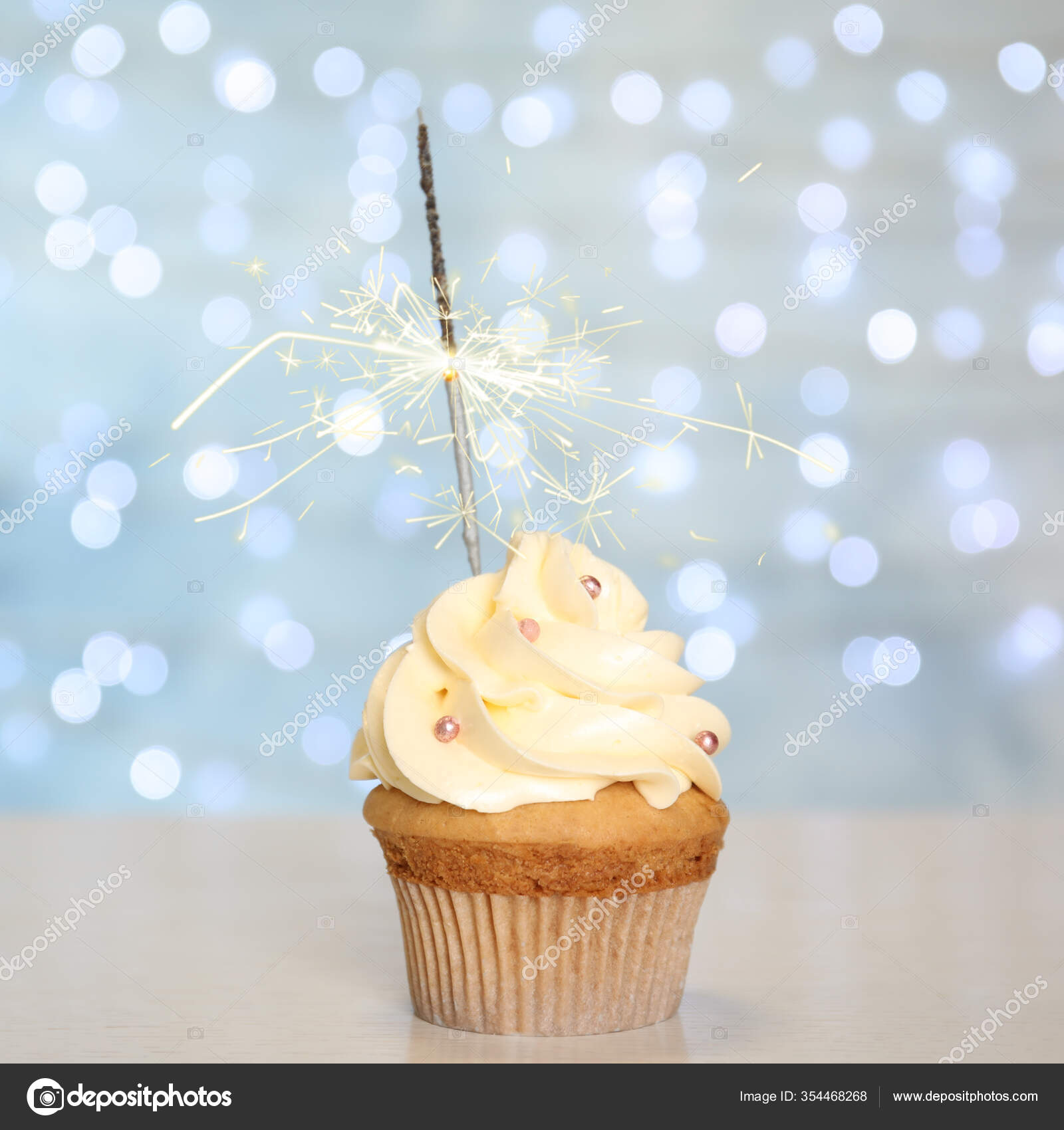 Cupcake with sparkling candle for 39th birthday or anniversary with big  number in white with yellow streamers on blue table with dark background  full Stock Photo - Alamy