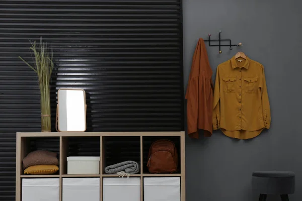 Hallway interior with stylish furniture, clothes and accessories