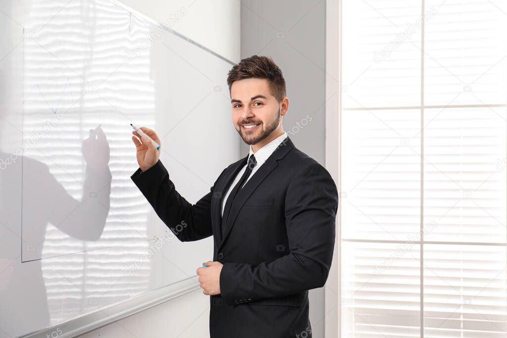 Professional business trainer near whiteboard in office