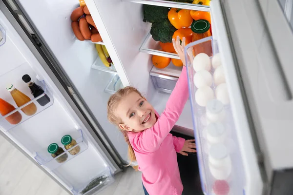 Little Girl Taking Bell Pepper Out Refrigerator Indoors View — Stock Photo, Image