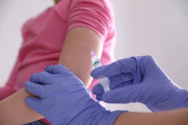 Küçük kız klinikte suçiçeği aşısı oluyor, yakın plan. Varicella virüs önleme