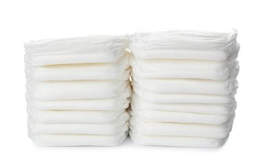 Stacks of baby diapers isolated on white clipart