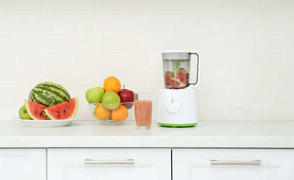 Blender and smoothie ingredients on counter in kitchen