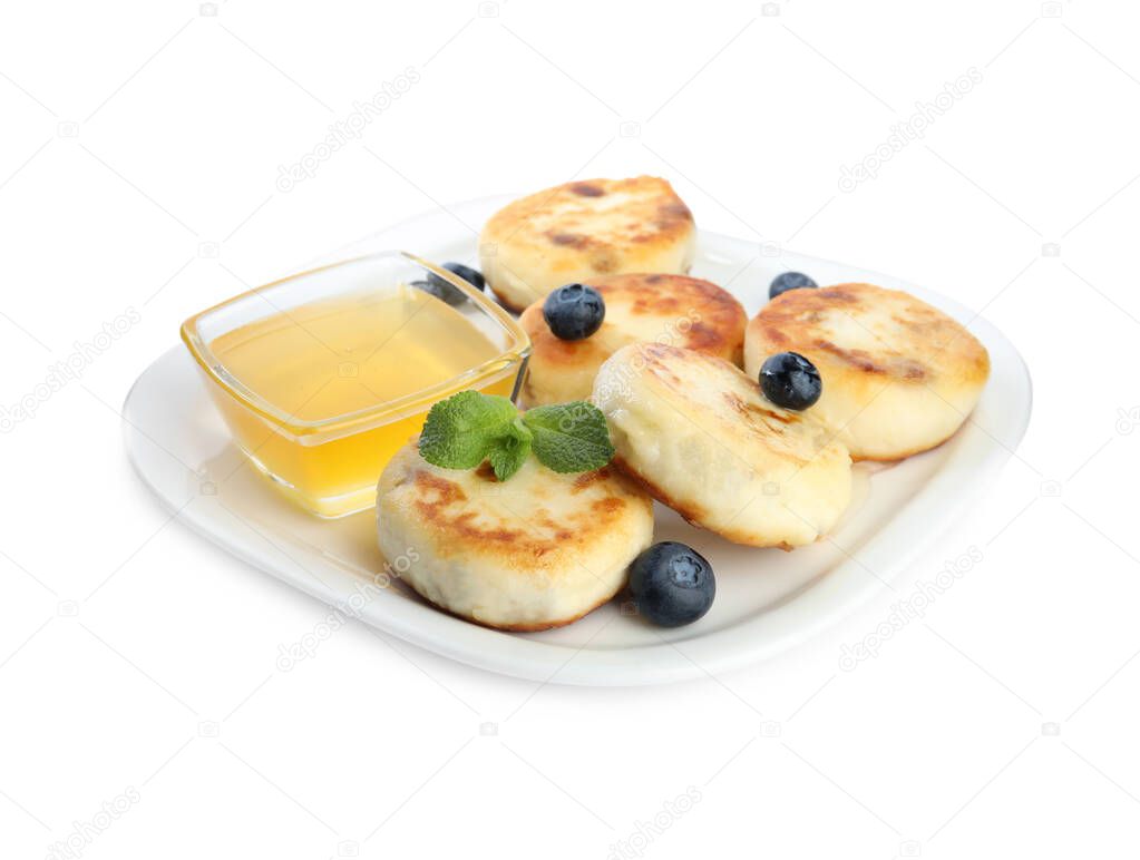 Delicious cottage cheese pancakes with blueberries, mint and honey isolated on white