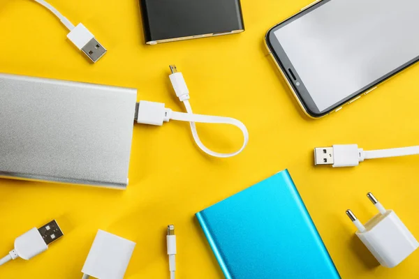 Mobile Phone Portable Chargers Yellow Background Flat Lay — Stock Photo, Image